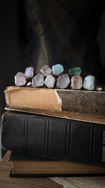 Collection of rings in kunzite, fluorite and aquamarine