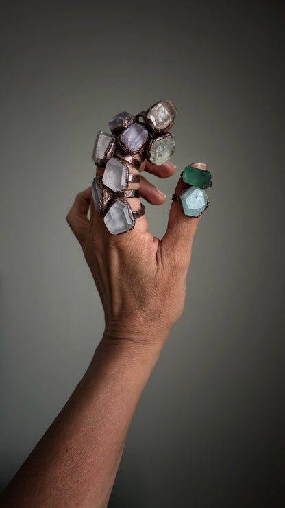 Collection of rings in kunzite, fluorite and aquamarine