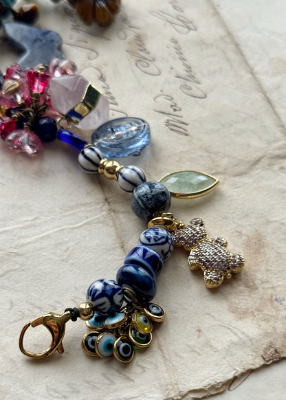 Bracelet with blue stones, flowers, teddy bears, butterflies and pendants - Model 13