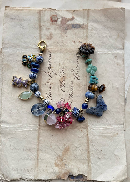 Bracelet with blue stones, flowers, teddy bears, butterflies and pendants - Model 13