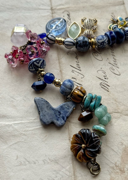 Bracelet with blue stones, flowers, teddy bears, butterflies and pendants - Model 13