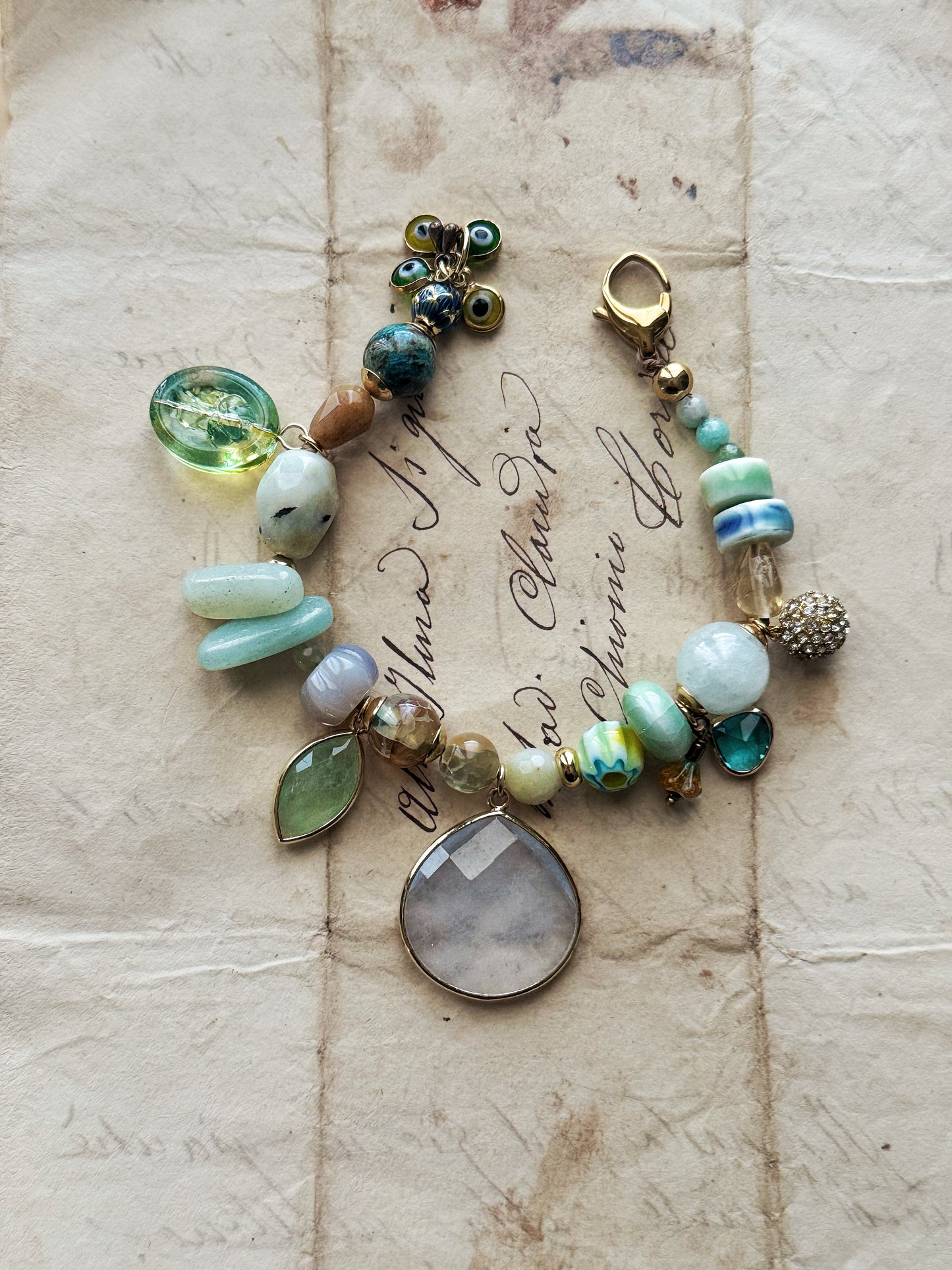 Bracelet with light blue Jade drop, mixed stones and charms - Model 03