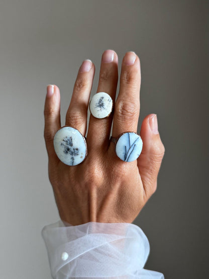 Rings with white dendritic agate stones.